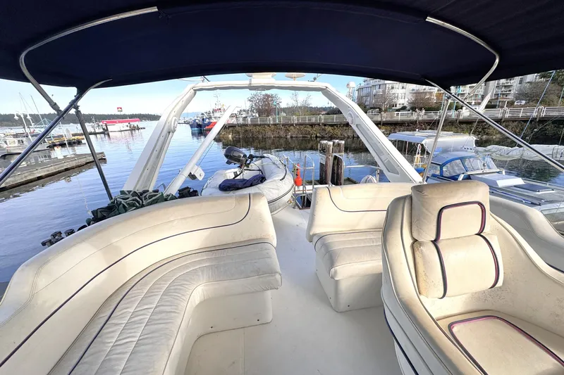  Yacht Photos Pics 1989 Bayliner 4588 Pilothouse yacht interior with seating, docked at marina.