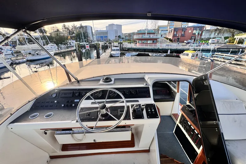  Yacht Photos Pics 1989 Bayliner 4588 Pilothouse helm with marina view at sunset.