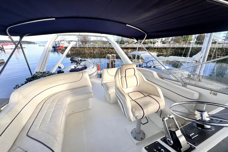 Yacht Photos Pics 1989 Bayliner 4588 Pilothouse yacht interior with seating and steering wheel, docked at marina.