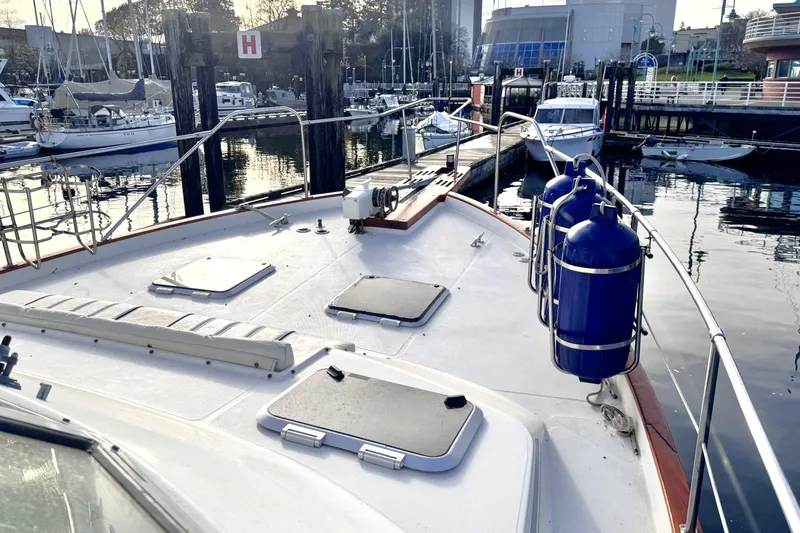  Yacht Photos Pics 1989 Bayliner 4588 Pilothouse yacht docked at marina, featuring deck and blue fenders.