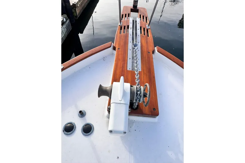 Yacht Photos Pics 1989 Bayliner 4588 Pilothouse anchor windlass on wooden deck, docked by water.