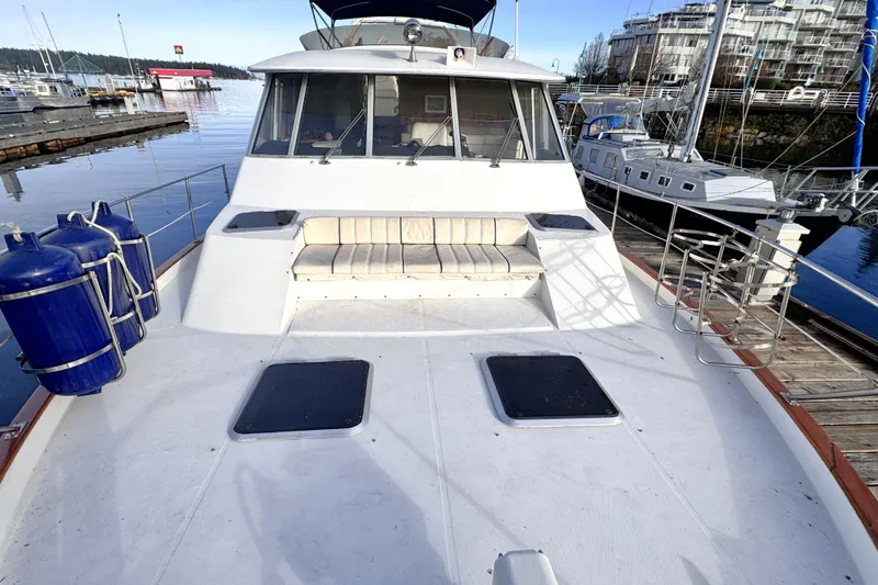  Yacht Photos Pics 1989 Bayliner 4588 Pilothouse yacht docked at marina, featuring spacious deck and seating area.