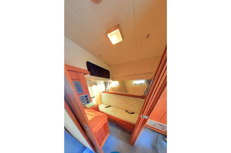  Yacht Photos Pics 1989 Bayliner 4588 Pilothouse interior cabin with striped seating and wood paneling.