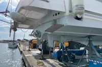 2016 Beneteau Swift Trawler 44 on dock, undergoing maintenance at marina.