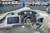 Helm of 2016 Beneteau Swift Trawler 44 with marina view in the background.