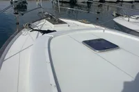 2016 Beneteau Swift Trawler 44 docked in a marina with other boats.