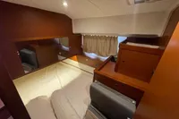 2016 Beneteau Swift Trawler 44 cabin interior with wood finish and cozy bed.