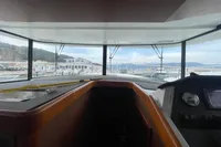 Interior view of 2016 Beneteau Swift Trawler 44, showcasing helm and panoramic windows.