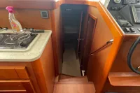 Interior view of 2016 Beneteau Swift Trawler 44, featuring wooden cabinetry and helm station.
