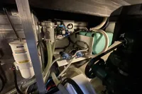 Engine room of 2016 Beneteau Swift Trawler 44 with visible hoses and machinery.