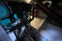 Engine room of 2016 Beneteau Swift Trawler 44 with visible machinery and fire extinguisher.