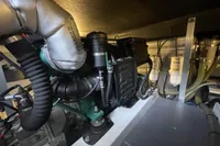Engine room of 2016 Beneteau Swift Trawler 44, showcasing mechanical components and filters.