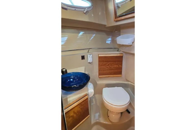 Free Range Yacht Photos Pics 2016 Cutwater C-28 LE boat bathroom with blue sink and wooden cabinets.