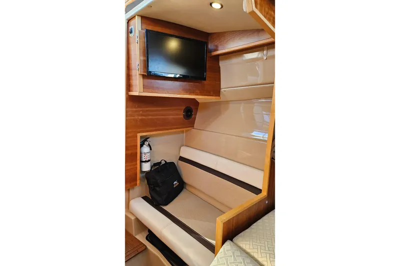 Free Range Yacht Photos Pics Interior of 2016 Cutwater C-28 LE boat with seating, TV, and fire extinguisher.