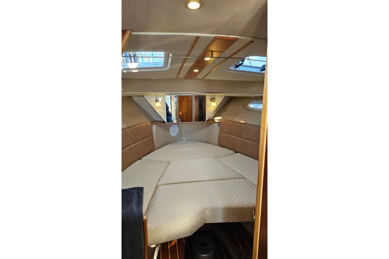 Free Range Yacht Photos Pics 2016 Cutwater C-28 LE cabin interior with cozy bed and elegant lighting.