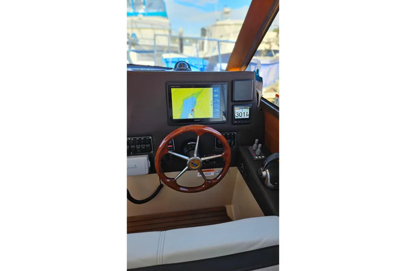 Free Range Yacht Photos Pics Helm of 2016 Cutwater C-28 LE with navigation display and wooden steering wheel.