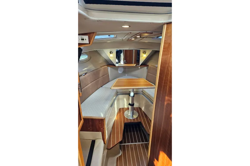 Free Range Yacht Photos Pics Interior of 2016 Cutwater C-28 LE boat with wooden table.