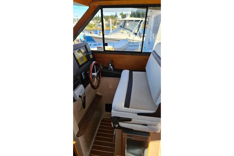 Free Range Yacht Photos Pics 2016 Cutwater C-28 LE boat interior with steering wheel and navigation controls.