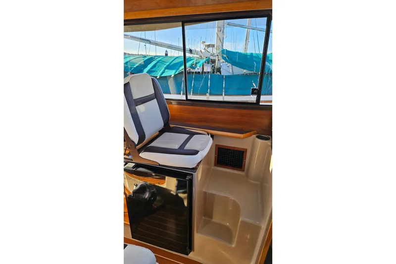 Free Range Yacht Photos Pics 2016 Cutwater C-28 LE interior with cushioned seat and window view.
