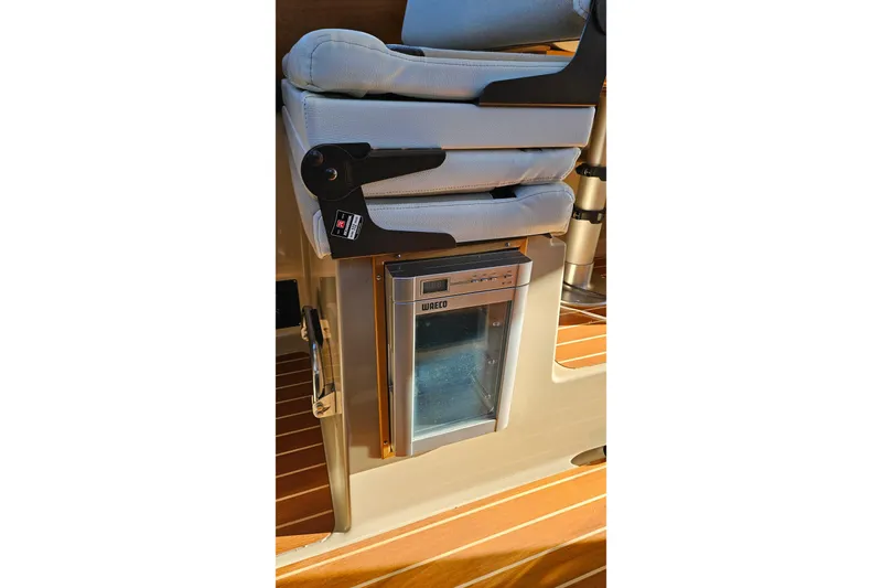 Free Range Yacht Photos Pics 2016 Cutwater C-28 LE interior with cushioned seat and compact fridge.