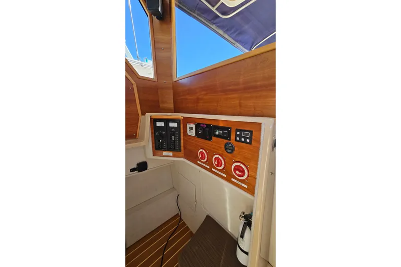 Free Range Yacht Photos Pics 2016 Cutwater C-28 LE boat interior control panel with wood finish and electrical switches.