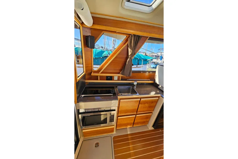 Free Range Yacht Photos Pics 2016 Cutwater C-28 LE boat interior kitchen with wood cabinetry and appliances.