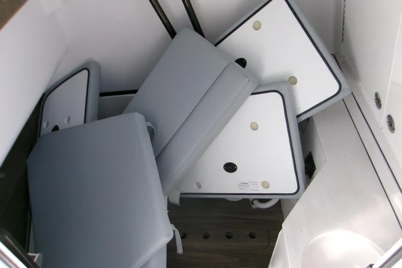  Yacht Photos Pics 2026 Sportsman Heritage 321 Center Console interior with folded cushions and storage area.