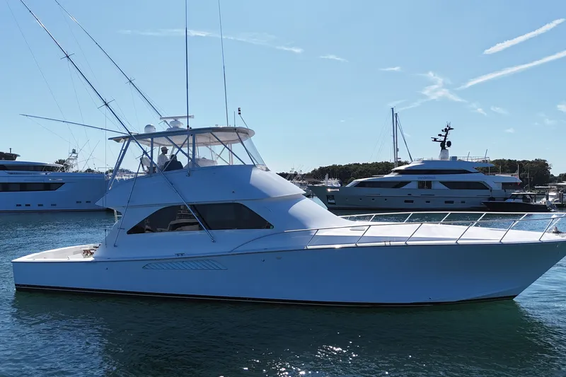 On The Ball Yacht Photos Pics 2006 Viking 56 Convertible yacht on water, with other boats in the background.