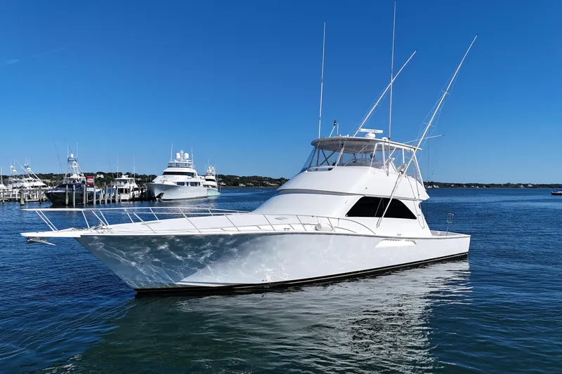 On The Ball Yacht Photos Pics 2006 Viking 56 Convertible yacht on calm water under clear blue sky.