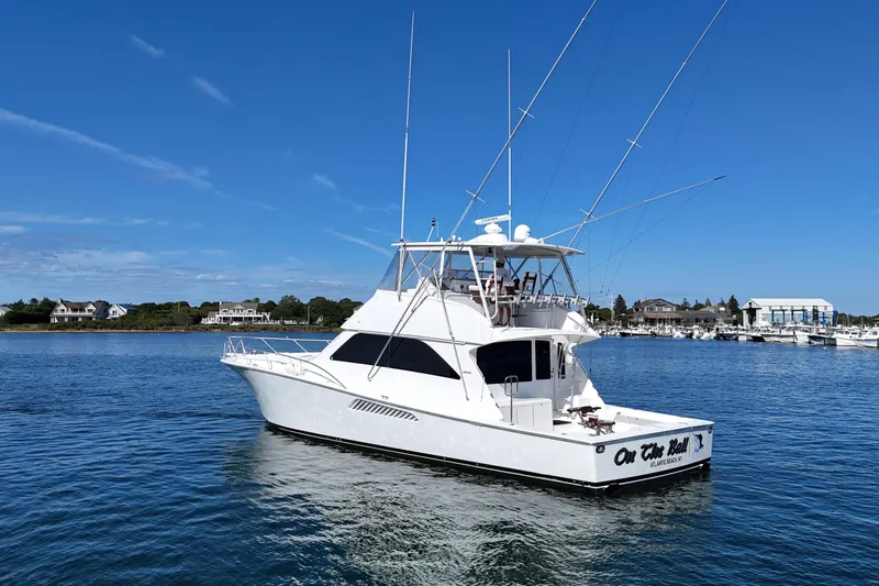 On The Ball Yacht Photos Pics 2006 Viking 56 Convertible yacht on calm water under clear blue sky.