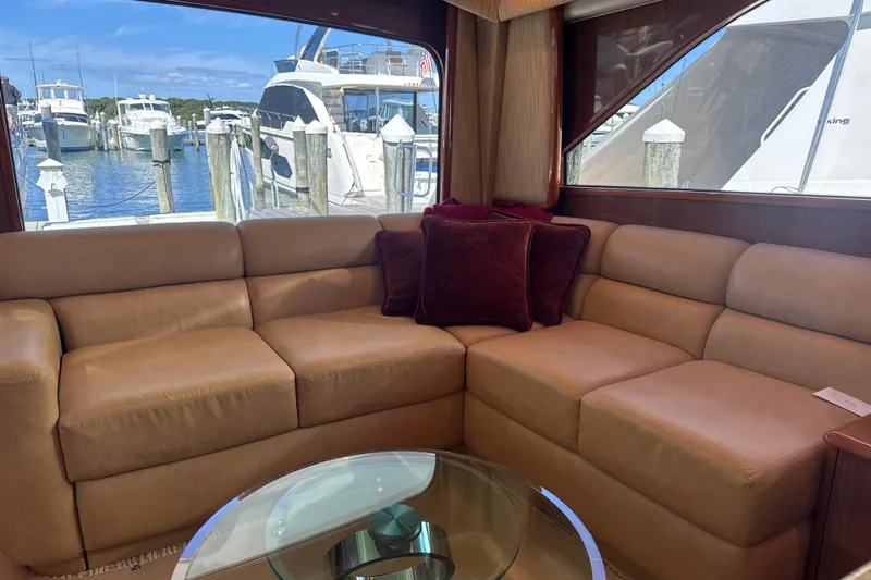 On The Ball Yacht Photos Pics Luxurious interior of 2006 Viking 56 Convertible yacht with leather seating and marina view.
