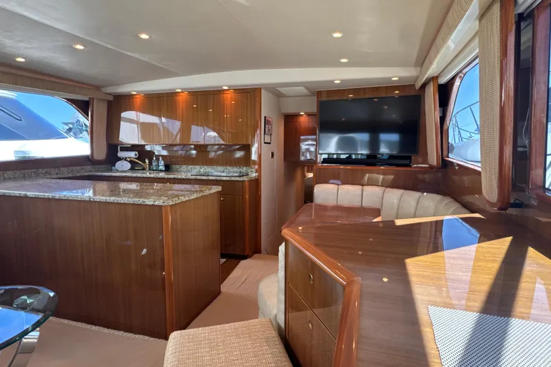 On The Ball Yacht Photos Pics Luxurious interior of a 2006 Viking 56 Convertible yacht with wood finishes and modern amenities.