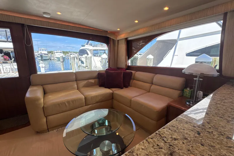 On The Ball Yacht Photos Pics Luxurious interior of 2006 Viking 56 Convertible yacht with leather seating and marina view.