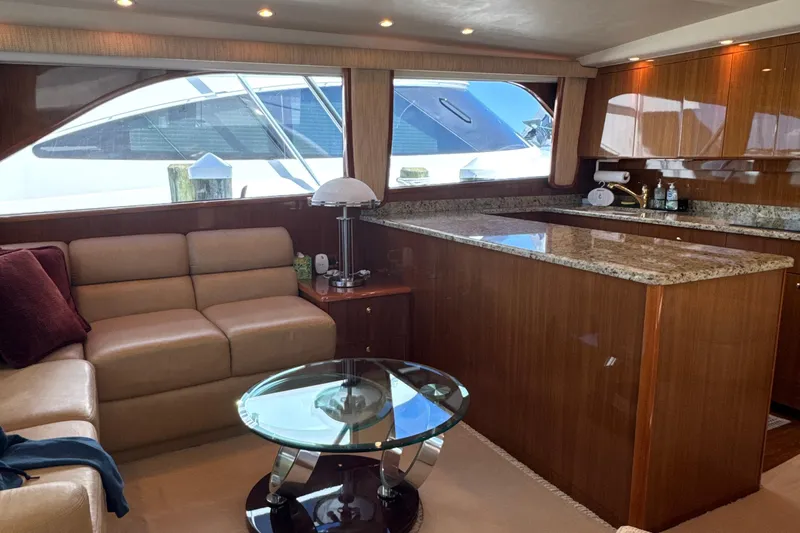 On The Ball Yacht Photos Pics Luxurious interior of a 2006 Viking 56 Convertible yacht with leather seating and granite countertops.