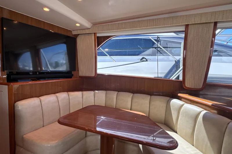 On The Ball Yacht Photos Pics Luxurious interior of 2006 Viking 56 Convertible yacht with plush seating and large TV.