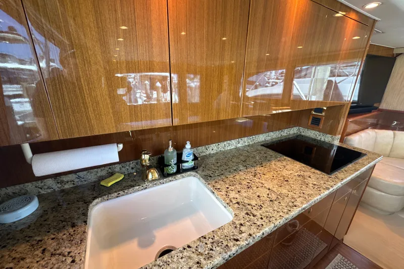 On The Ball Yacht Photos Pics Luxurious kitchen interior of 2006 Viking 56 Convertible yacht with granite countertops.