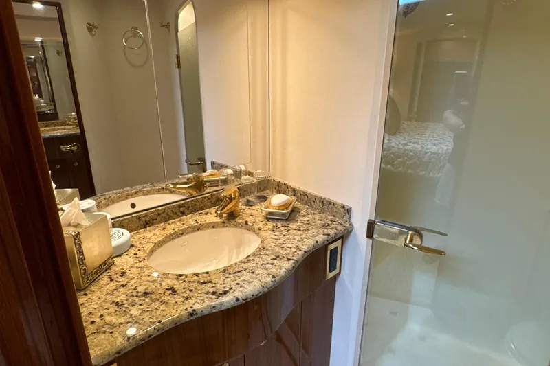 On The Ball Yacht Photos Pics Luxurious bathroom in 2006 Viking 56 Convertible yacht with granite countertop and elegant fixtures.