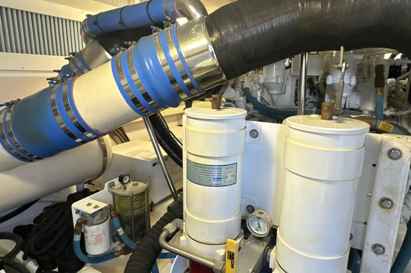 On The Ball Yacht Photos Pics Engine room of 2006 Viking 56 Convertible yacht with visible filters and piping.