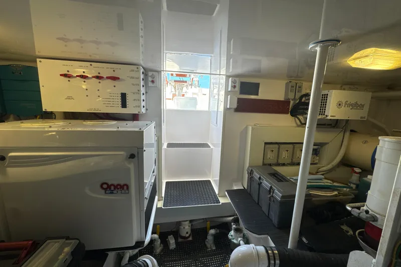 On The Ball Yacht Photos Pics Engine room of a 2006 Viking 56 Convertible yacht, featuring Onan generator and Frigibar equipment.