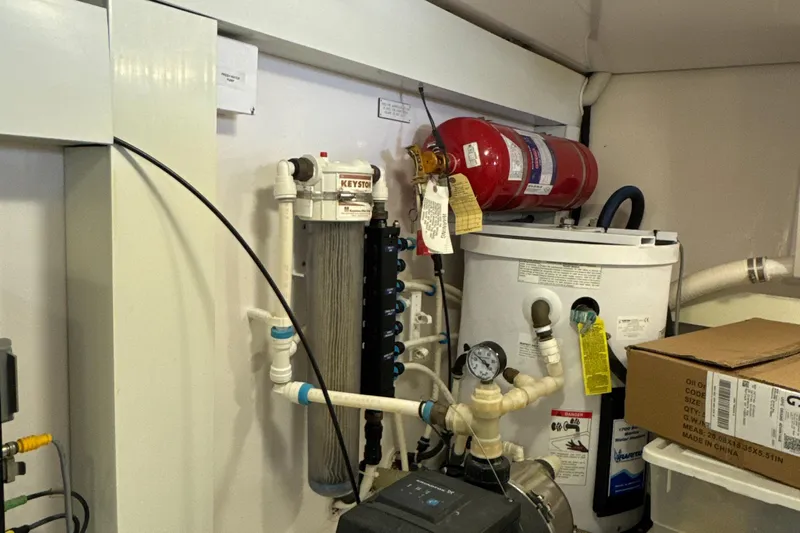 On The Ball Yacht Photos Pics Engine room of a 2006 Viking 56 Convertible with fire extinguisher and water filtration system.