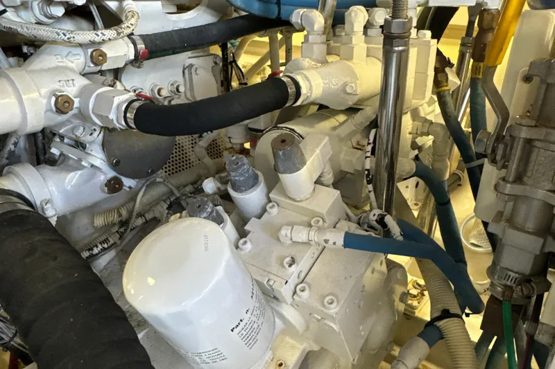 On The Ball Yacht Photos Pics Engine room of 2006 Viking 56 Convertible yacht, showcasing complex machinery and components.