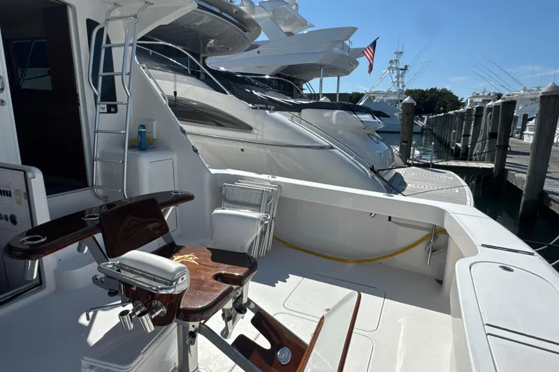 On The Ball Yacht Photos Pics 2006 Viking 56 Convertible yacht docked, featuring a fishing chair and marina view.