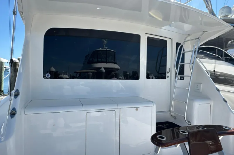 On The Ball Yacht Photos Pics 2006 Viking 56 Convertible yacht with sleek white exterior and ladder access.