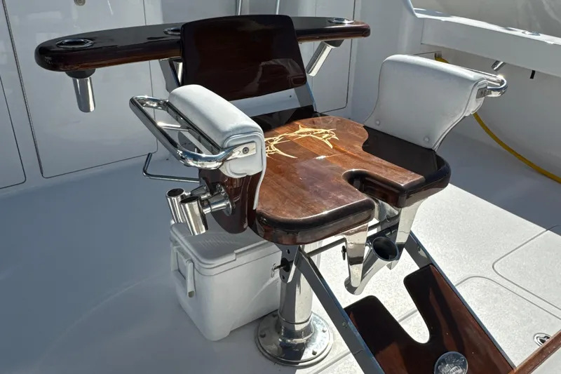 On The Ball Yacht Photos Pics Fishing chair on 2006 Viking 56 Convertible yacht, featuring wooden armrests and rod holders.