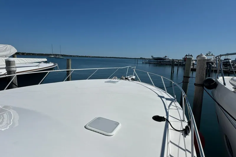 On The Ball Yacht Photos Pics 2006 Viking 56 Convertible yacht docked at a marina under clear blue skies.