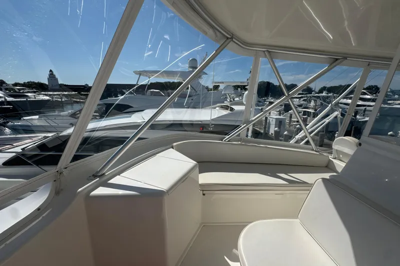 On The Ball Yacht Photos Pics 2006 Viking 56 Convertible yacht interior with marina view, featuring sleek white seating.