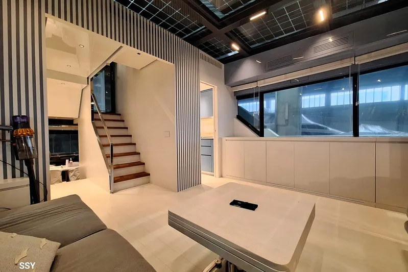 Mabelle Yacht Photos Pics Luxurious interior of 2022 Arcadia Yachts Sherpa 80 XL with modern design and elegant staircase.