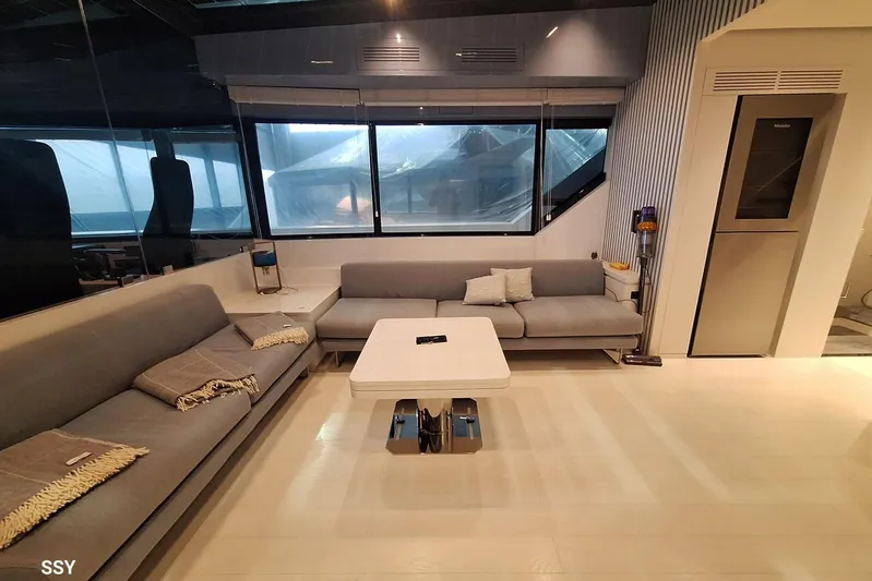 Mabelle Yacht Photos Pics Luxurious interior of 2022 Arcadia Yachts Sherpa 80 XL with modern seating and sleek design.