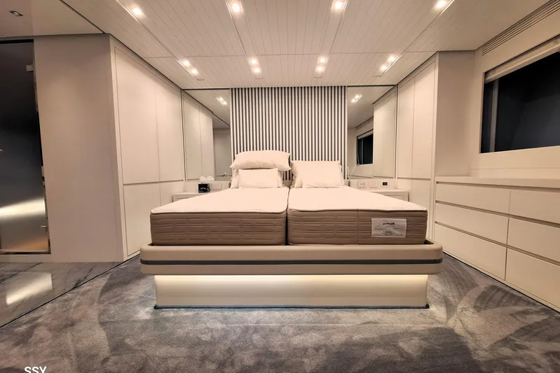 Mabelle Yacht Photos Pics Luxurious bedroom interior of 2022 Arcadia Yachts Sherpa 80 XL, featuring modern design and ambient lighting.
