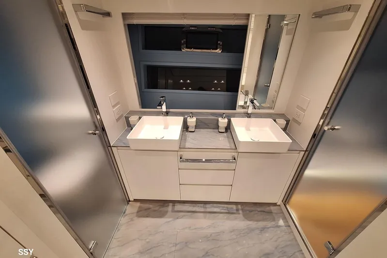 Mabelle Yacht Photos Pics Luxury bathroom on 2022 Arcadia Yachts Sherpa 80 XL with dual sinks and modern design.